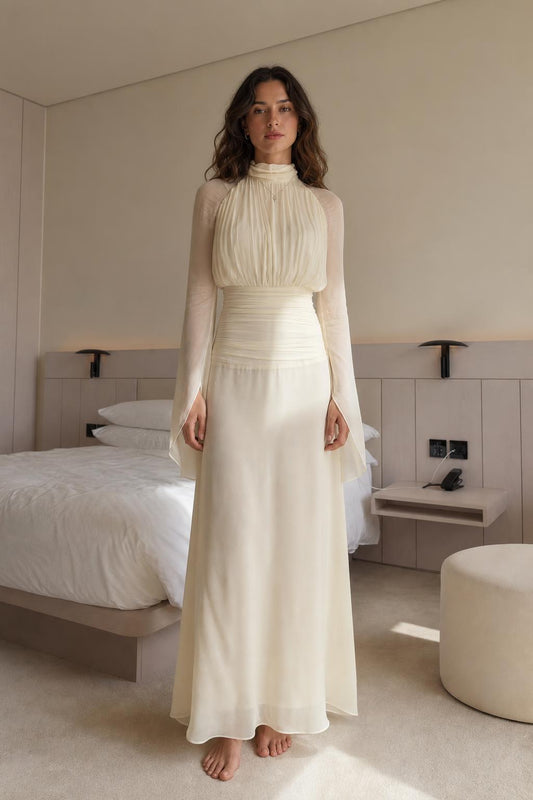 Front view of woman wearing cream pleated high-neck long-sleeve maxi dress