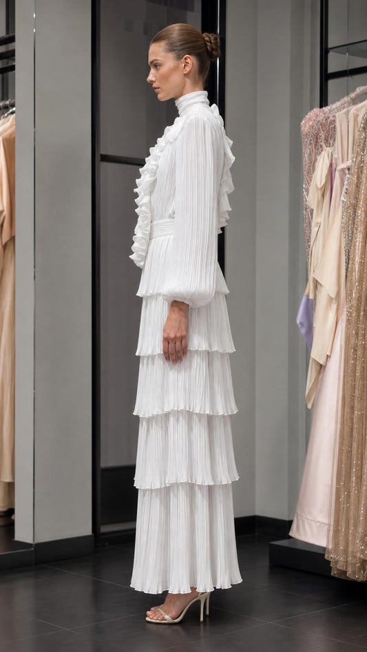 Side profile of white tiered maxi dress with long sleeves