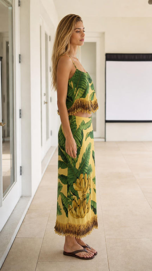 Side profile view of model wearing the yellow tropical two-piece skirt set