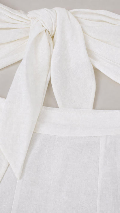 Close-up of fabric texture and front knot detail on white top