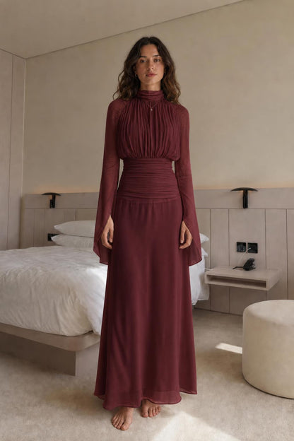 Front view of woman wearing burgundy pleated maxi dress